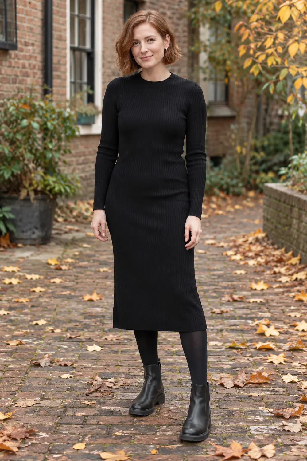 Long-sleeve black ribbed midi dress with opaque tights and black Chelsea boots
