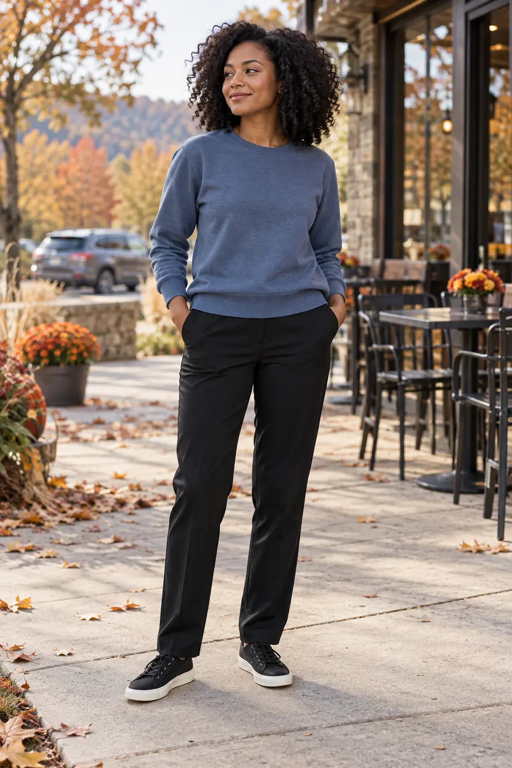 Slate-blue sweatshirt, black straight-leg stretch trousers, and black low-top sneakers